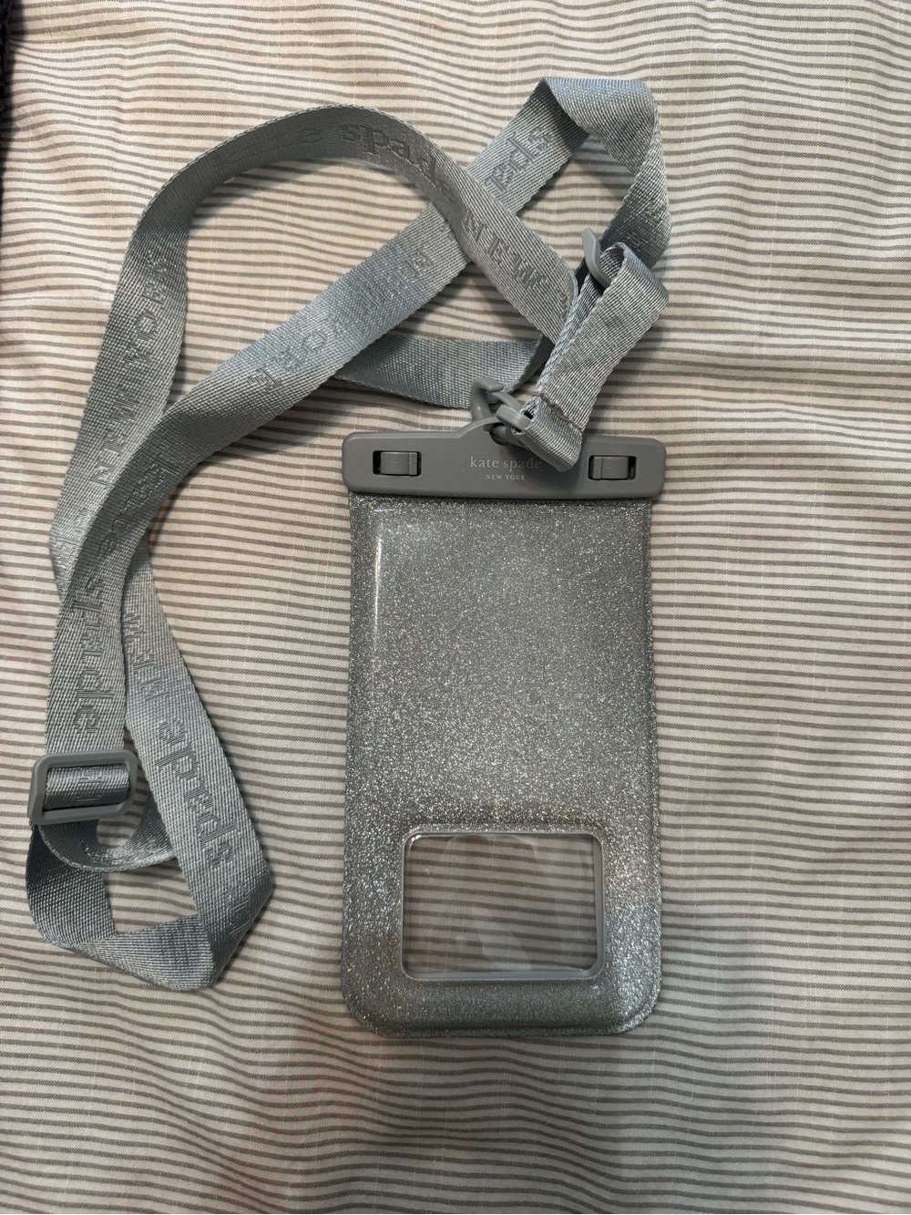 kate spade silver glitter waterproof phone pouch with gray strap